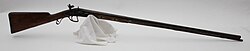 English or French smoothbore flintlock shotgun with an engraved iron mounting