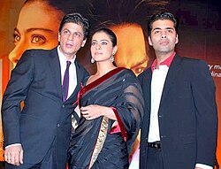 Shah Rukh Khan, Kajol, and Karan Johar pose for the camera.