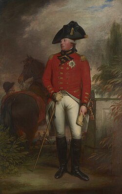 George wearing the red jacket of an 1800 British army general with the star of the Order of the Garter, white breeches, black knee-high boots, and a black bicorne hat. Behind him a groom holds a horse.