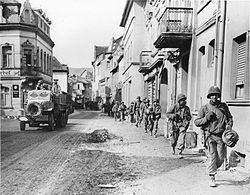 American Soldiers march through a German town in 1945
