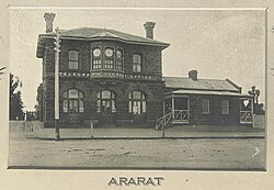 A two-storey building on the left (the Post Office) and a one-story building on the right. Both constructed from bluestone.