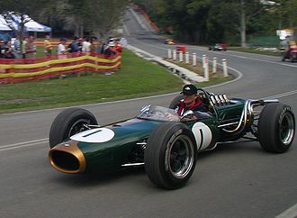 A green cigar-shaped racing car with exposed wheels and an open cockpit. The number one is painted on the nose and sides.