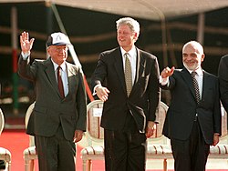 Clinton during the signing of the Israel–Jordan peace treaty, with Yitzhak Rabin (left) and King Hussein of Jordan (right)