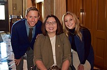 Three people smiling at the camera
