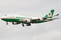 Double-deck aircraft in flight, with deployed landing gear