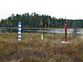 Finland–Russia border markers: a white marker for the actual border, "guarded" by striped bollards