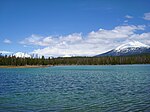 View to the northeast across Lava Lake with three volcanic mountains in the background: South Sister, Broken Top, and Mount Bachelor.