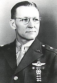 Head and shoulders view of man in military uniform with decorations.