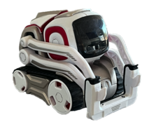 A small, white and gray robot with red highlights and a square black face