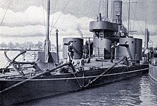 a black and white image of a ship alongside