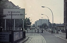 A sign reading "Until we see each other again in the capital of the GDR"