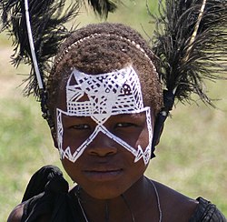 Young Maasai Warrior, with head-dress and face painting.