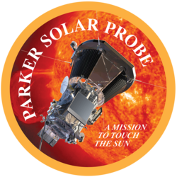 Artwork of the spacecraft next to the Sun, enclosed in a circle with a yellow border. The words "Parker Solar Probe" are placed around the interior of the border, while the words "a mission to touch the Sun" are written inline in a smaller font in the bottom right of the image.