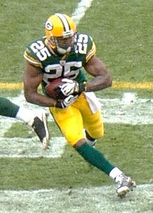 Grant in uniform rushing the ball during a game