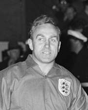 A black and white photograph of Billy Wright, wearing an England national team jersey.