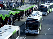 Articulated bus pulling out of a station