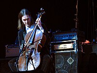 This image shows musician Don Kerr playing cello through a bass amplifier. While bass amplifiers are typically designed for the electric bass and/or the double bass, other instrumentalists use bass amps, including some electric guitarists and other instrument players.