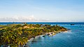 Aerial view of a beach on Union Island near Clifton with the Union Island Airport in the background.