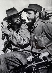 Fidel Castro gives a speech, while Camilo Cienfuegos watches from his side