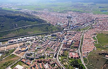 Aerial view of Talavera de la Reina showing a dense city surrounded by greenery