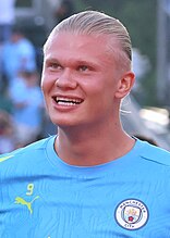 Erling Haaland wearing a blue football jersey.