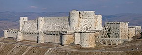 A large stone castle on a hill