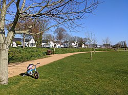 St Martin's Village, including (from left to right) the la Vielle École (village shopping centre), Public Hall and Parish Church. In the foreground is the village green.