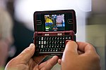 A person in the audience at Monaco RV manufacturing in Wakarusa, Ind. uses their cell phone to record President Barack Obama's remarks on the economy, August 5, 2009.