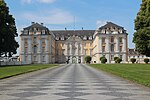 A front view of a large Rococo palace with a road in front