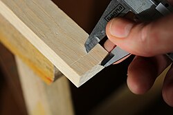 Marking a set or measured distance from an edge by scraping a line with the sharp sides of the beak