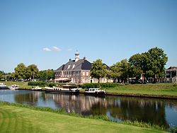 Ommen's old town hall, the river Vecht, and the city centre in the background.