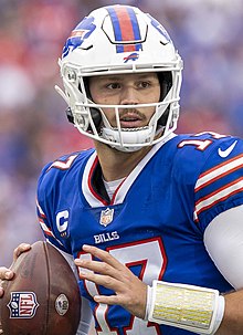 Josh Allen in a Buffalo Bills jersey and helmet preparing to throw a football.