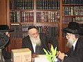 Rabbi Meir Tzvi Bergman with a packaged set of Oz Vehadar Mishna Berurahs