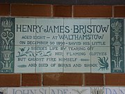 A tablet formed of six standard sized tiles, bordered by green flowers in the style of the Arts and Crafts movement