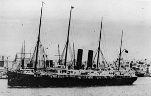 Black and white photograph of the ship in an unidentified harbour.