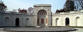 A neoclassical exedra with central apse, inlaid with red granite