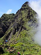 Hikers prepare to climb up the summit peak from the north side (Tampayan trail).