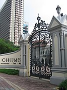 A large metal gate stands connects to a small wall