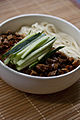 Zhájiàng Miàn (noodles with bean paste) is a traditional northern Chinese dish.