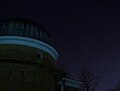 Observatory dome with the constellation Orion in the background.