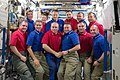 STS-132 (blue shirts) and Expedition 23 crew members pose for a group portrait on the ISS.