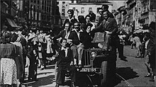 American jeep overloaded with Grenoble residents in Grenette square.