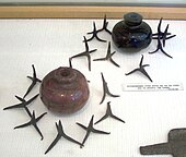 Two pots surrounded by caltrops