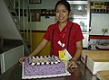 A whole chiffon Ube cake being served for a birthday party