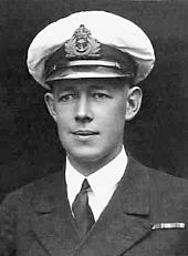 Formal head-and-shoulders portrait of young man in winter naval uniform with peaked cap