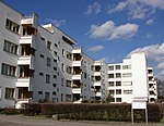 A long four-storey apartment building in Modernist style