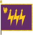 The traditional colour of the Eastern Finland Signals Battalion, part of the Karelia Brigade, has the branch colours of signals corps: purple and gold. The device featuring a western capercaillie is a throwback to the earlier designation as Central Finland Signals Battalion. The main device, the three lightning bolts, is symbolic of communication.