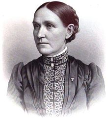 chest high portrait wearing a dress with subject's hair pinned up