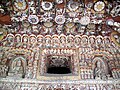 Cave 12. Phase II, after 650 AD. Yungang Grottoes, Datong: a riot of decoration is illustrated here, with Buddhas, musicians, and apsarasas.