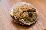 Two carrot cake cookies with a cream filling between them